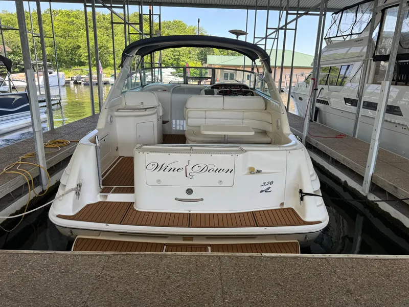 Slide: The Image of 1998 Sea Ray 330 Sundancer docked, rear view with Wine Down name. - 11