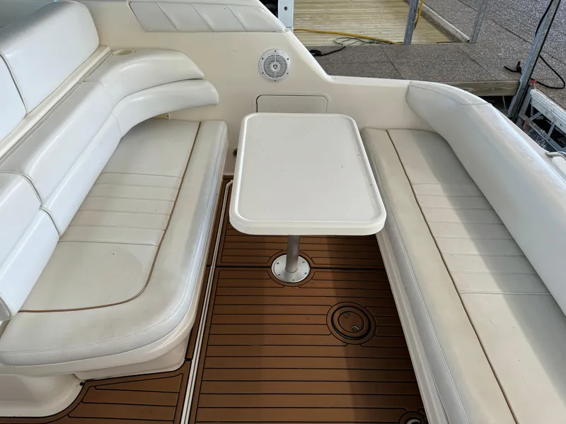 Slide: The Image of 1998 Sea Ray 330 Sundancer boat interior with white seating and table. - 13