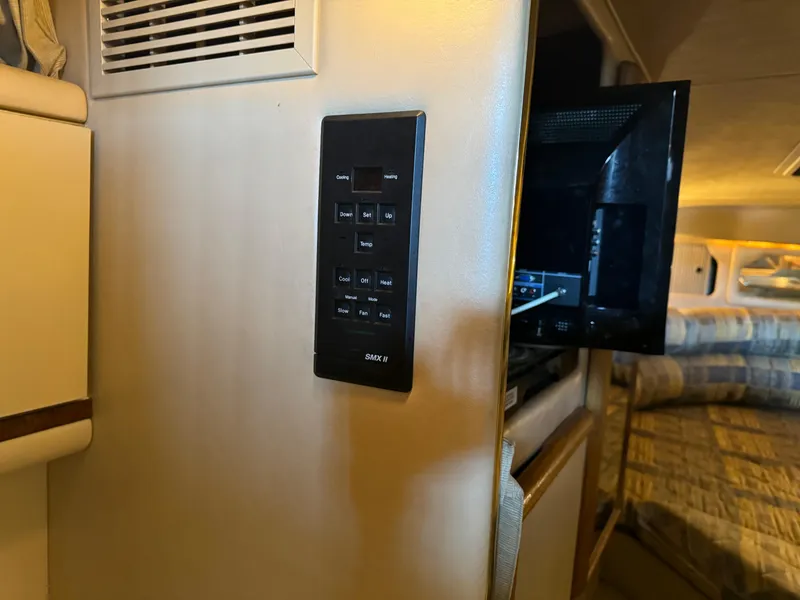 Slide: The Image of Control panel and TV in the cabin of a 1998 Sea Ray 330 Sundancer boat. - 20
