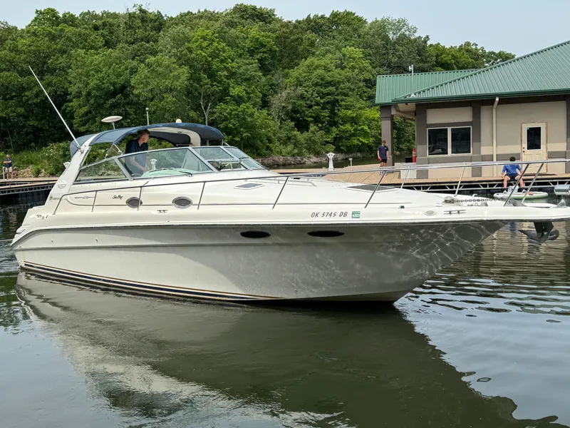 Slide: The Image of 1998 Sea Ray 330 Sundancer boat docked near a marina. - 4