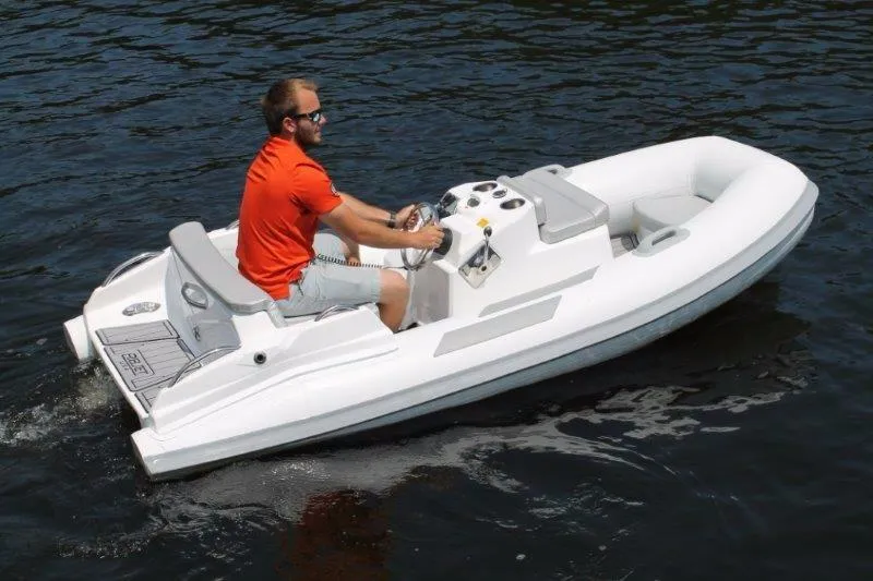 Slide: The Image of 2018 Ribjet 10 Jet Yacht Tender on water with driver in orange shirt. - 11