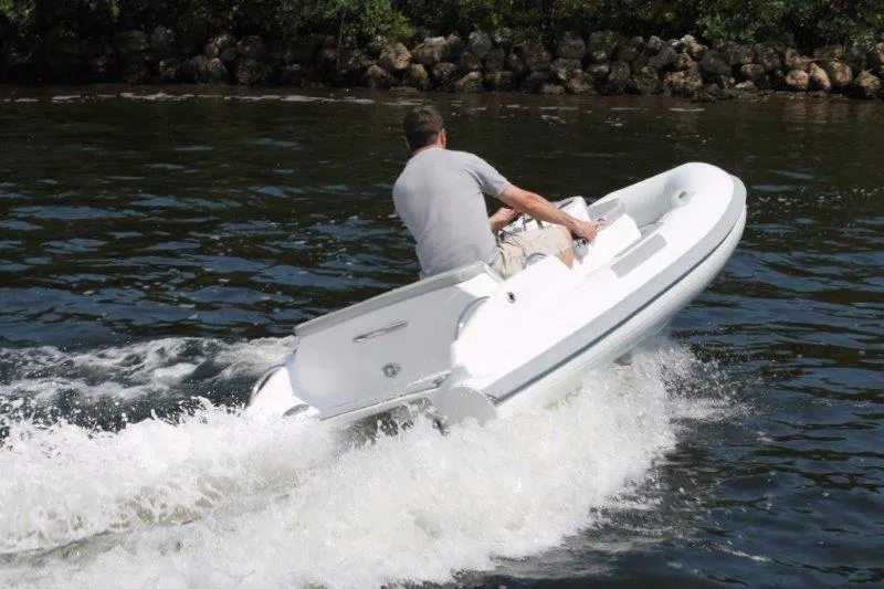 Slide: The Image of Man driving a 2018 Ribjet 10 Jet Yacht Tender on water. - 7