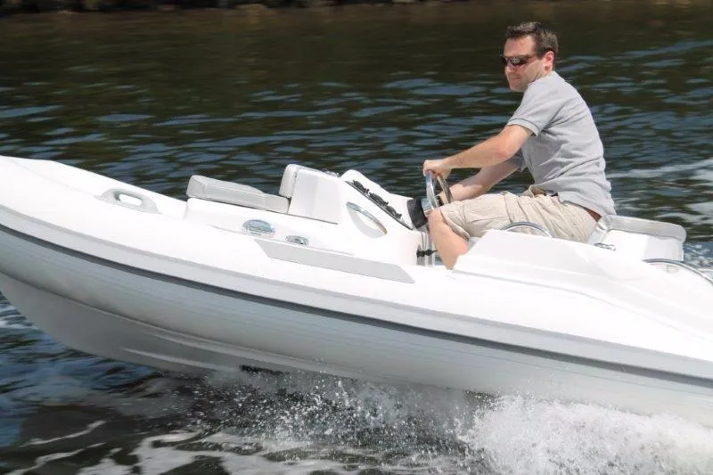 Slide: The Image of Man driving 2018 Ribjet 10 Jet Yacht Tender on water. - 8
