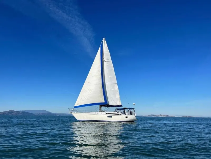 The Image of Sailboat Gib'Sea 126, 1985 model, cruising on calm blue waters under clear skies. - 1