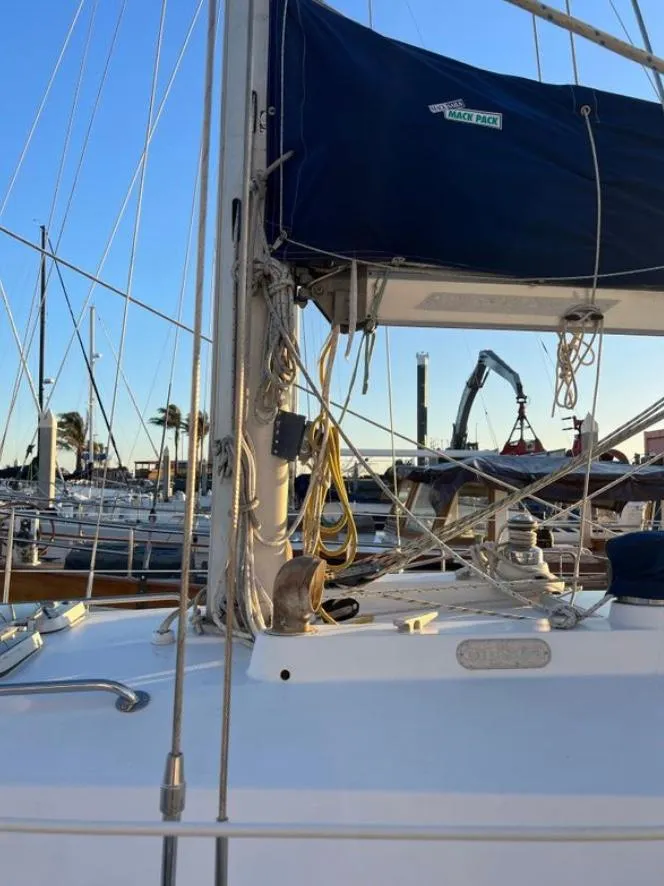 Slide: The Image of 1985 Gib'Sea 126 sailboat docked, featuring rigging and mast details. - 12