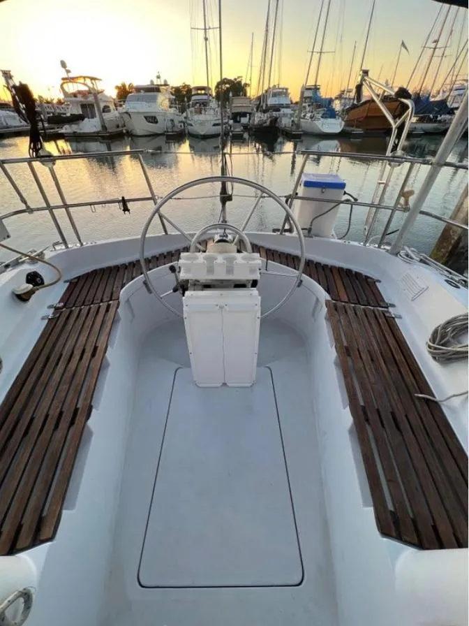 Slide: The Image of 1985 Gib'Sea 126 sailboat cockpit with wooden benches, docked at sunset. - 19