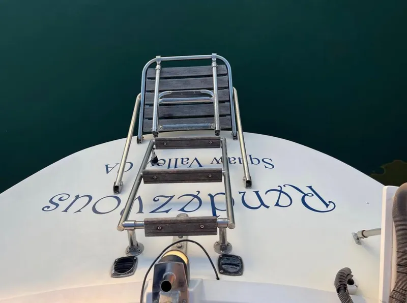 Slide: The Image of Gib'Sea 126 sailboat stern with ladder, 1985 model, docked in calm water. - 25