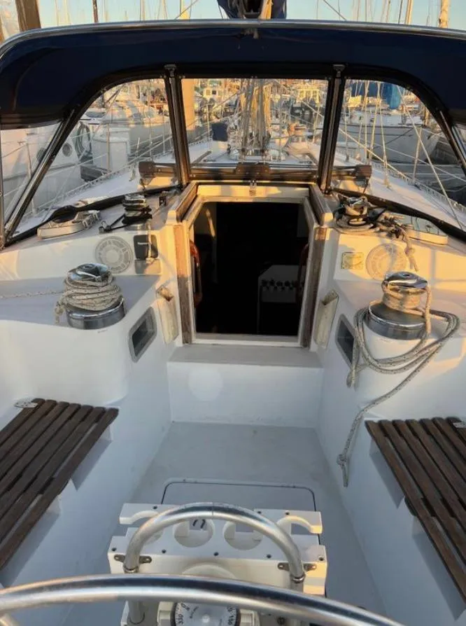 Slide: The Image of 1985 Gib'Sea 126 sailboat cockpit with winches and seating, docked at marina. - 32