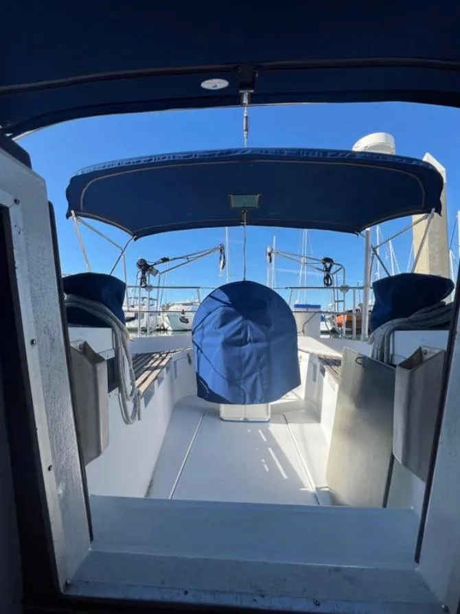Slide: The Image of 1985 Gib'Sea 126 sailboat cockpit with blue canopy and clear sky background. - 34