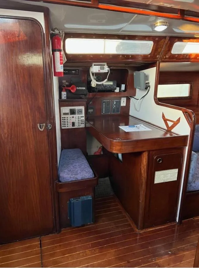 Slide: The Image of 1985 Gib'Sea 126 yacht interior with navigation station and wooden finish. - 37
