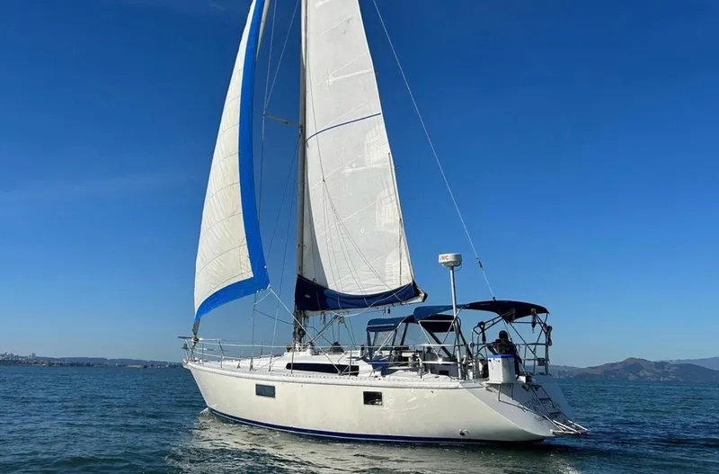 Slide: The Image of Sailing yacht Gib'Sea 126, 1985 model, cruising on open water under clear blue skies. - 4