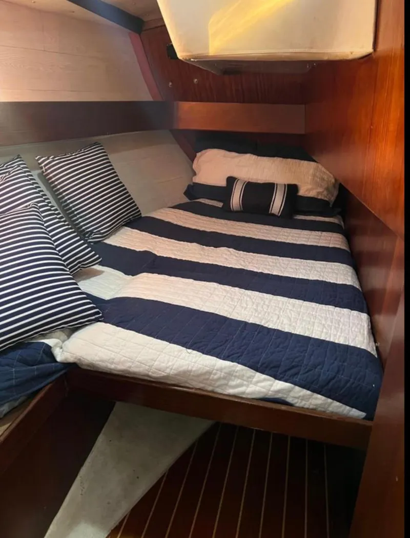 Slide: The Image of Cozy cabin interior of 1985 Gib'Sea 126 sailboat with striped bedding. - 45