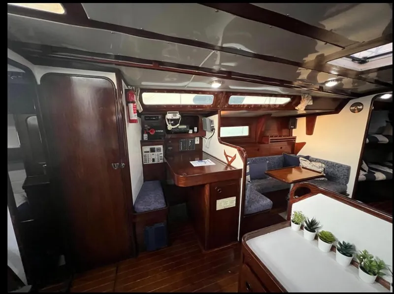 Slide: The Image of Interior of 1985 Gib'Sea 126 sailboat with wooden furnishings and cozy seating area. - 48