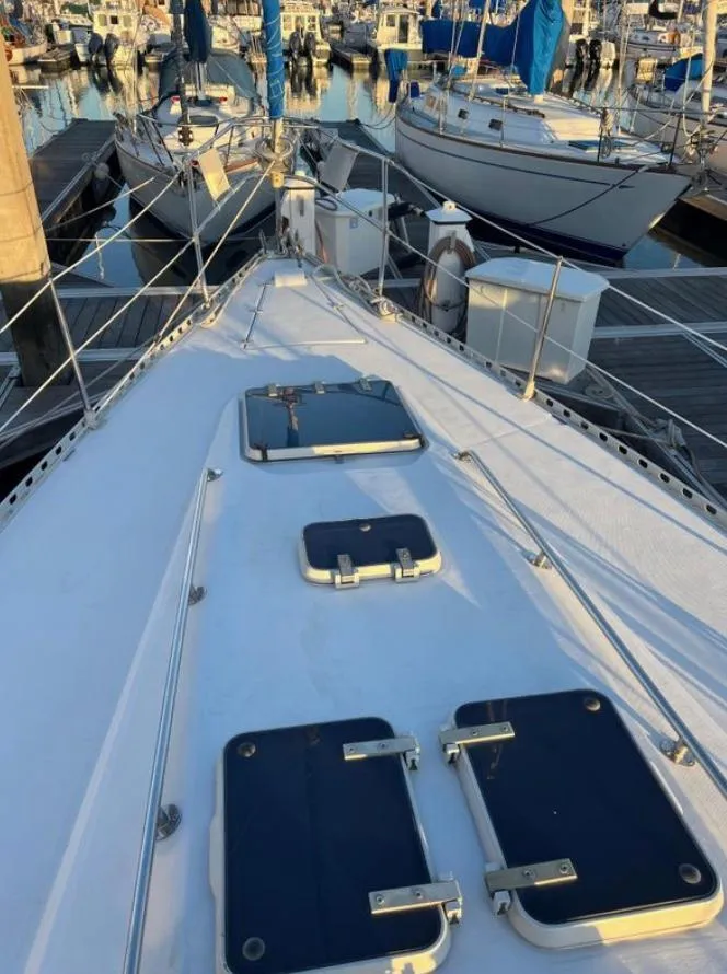 Slide: The Image of 1985 Gib'Sea 126 sailboat deck view at marina, surrounded by other boats. - 8