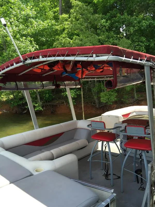 Slide: The Image of 2002 Harris-Kayot Royal Heritage 260 pontoon boat with red canopy and seating. - 11