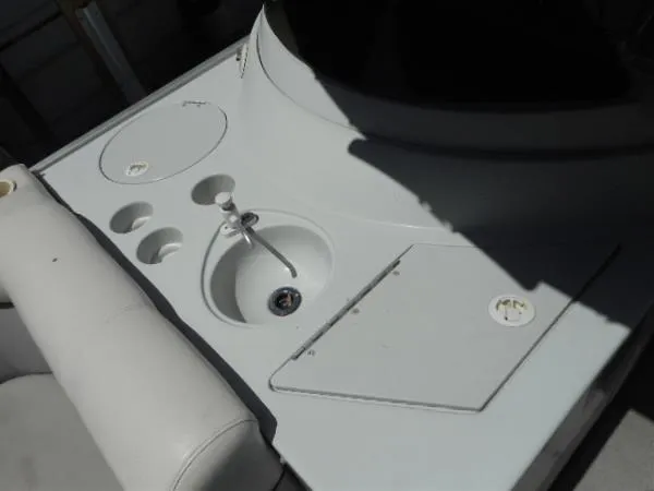 Slide: The Image of 2002 Harris-Kayot Royal Heritage 260 boat interior with sink and storage compartments. - 16