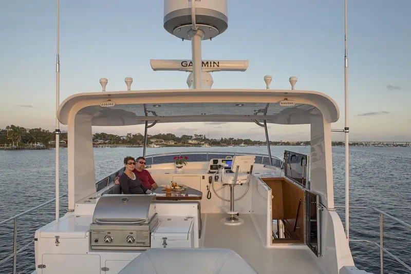 Slide: The Image of Couple relaxing on the deck of a 2025 Krogen 50 Open yacht. - 13