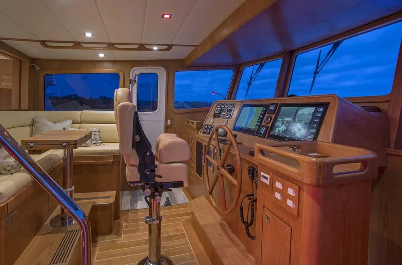 Slide: The Image of Interior of 2025 Krogen 50 Open yacht with modern navigation equipment and cozy seating area. - 4