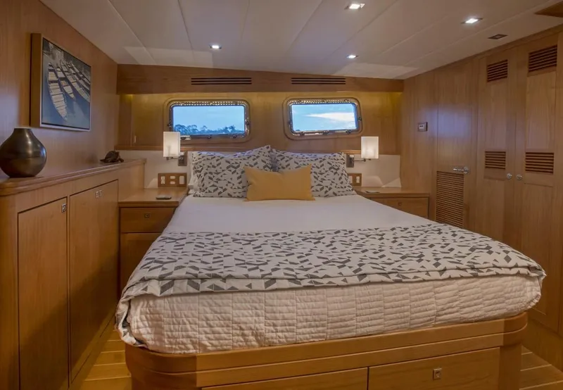 Slide: The Image of Luxurious bedroom in 2025 Krogen 50 Open yacht with modern decor and large bed. - 7