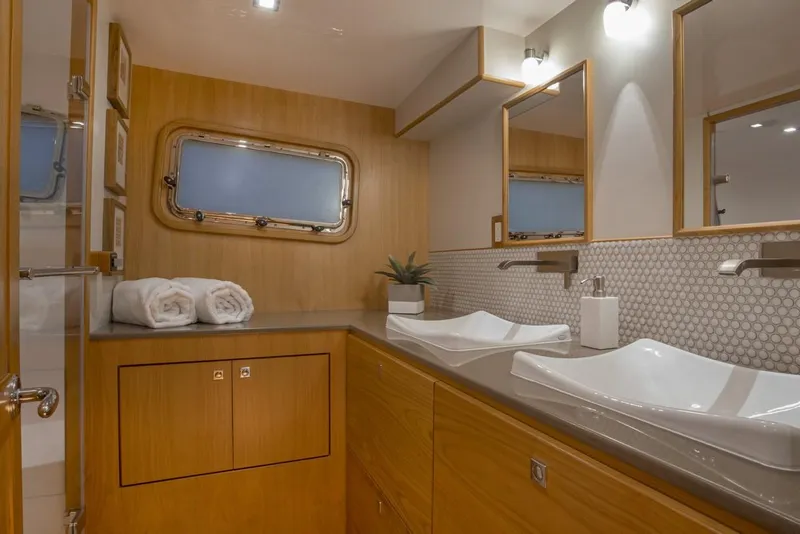 Slide: The Image of Modern bathroom in 2025 Krogen 50 Open yacht with dual sinks and wooden cabinetry. - 8