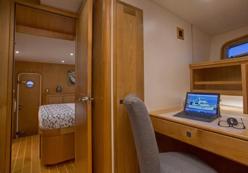 Slide: The Image of 2025 Krogen 50 Open yacht interior with desk, laptop, and bedroom. - 9