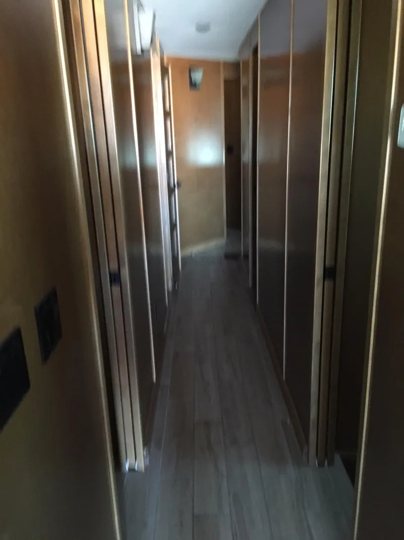 Slide: The Image of Narrow hallway inside 2014 Bravada Imagination Trip #15, featuring wooden paneling and flooring. - 11
