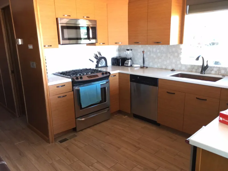 Slide: The Image of Modern kitchen with wooden cabinets, stainless steel appliances, and tiled backsplash in Bravada Imagination Trip #15. - 8