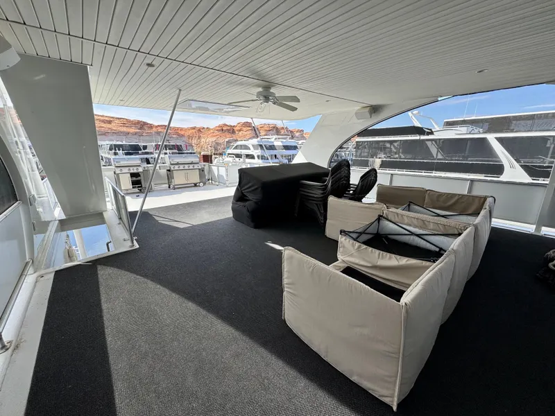 Slide: The Image of Outdoor deck of 2012 Bravada Helios Share #8 with grills, docked houseboats, and scenic cliffs. - 22