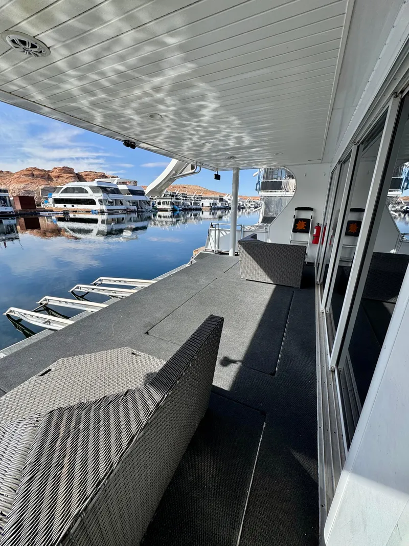 Slide: The Image of White boat seat on Bravada Helios Share #8, 2012, with metal railing and ocean backdrop. - 25