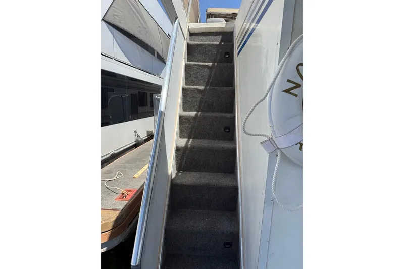 Slide: The Image of Staircase on 2004 Sharpe Houseboat San Juan Sunrise, with life preserver visible. - 13