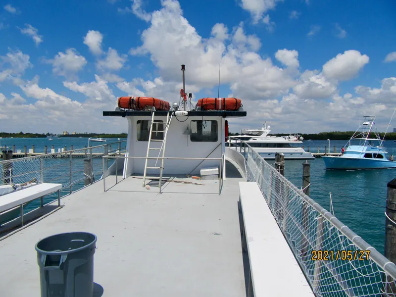 Slide: The Image of Commercial drift fishing boat docked, 1986 model, with life rafts and clear skies. - 16