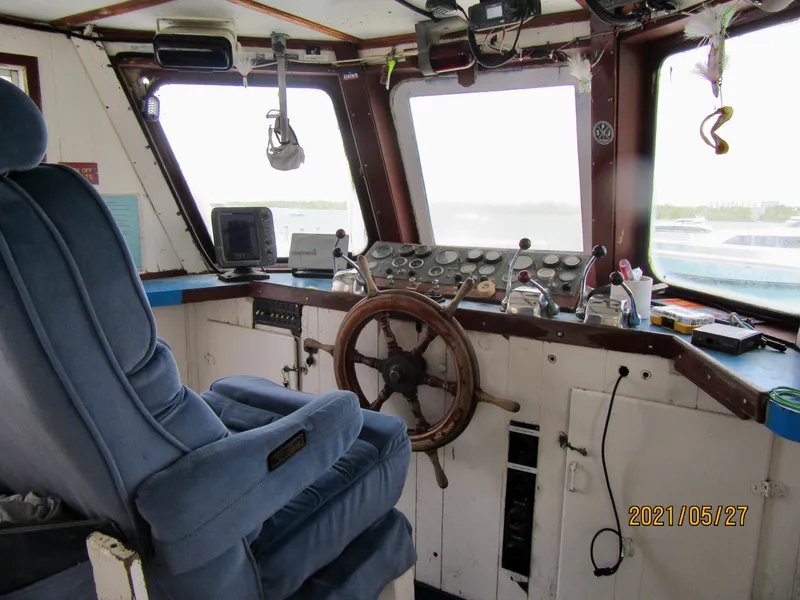 Slide: The Image of Interior of 1986 Drift Fishing Party boat cockpit with steering wheel and control panel. - 26