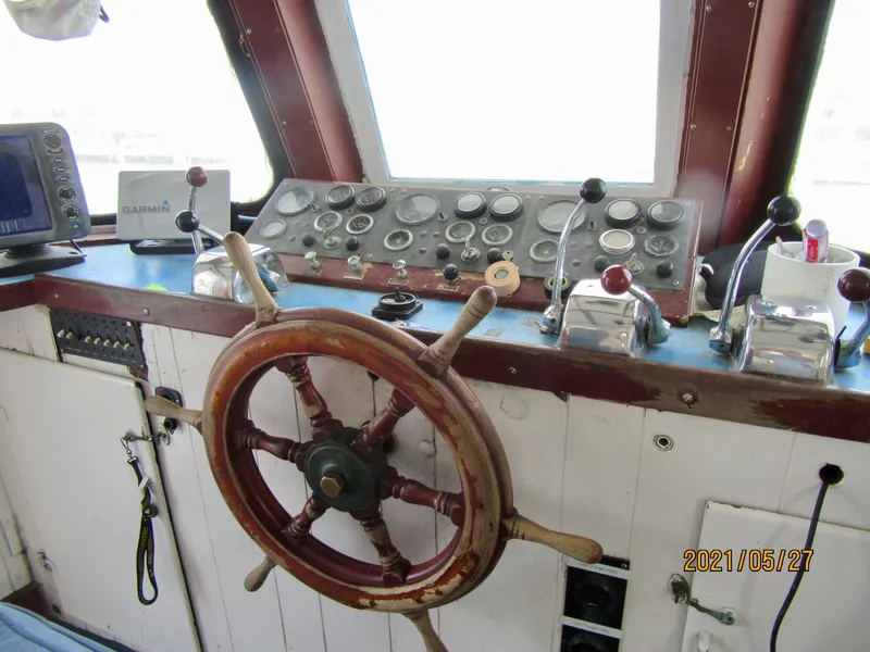 Slide: The Image of Vintage 1986 commercial fishing boat helm with wooden wheel and control panel. - 27
