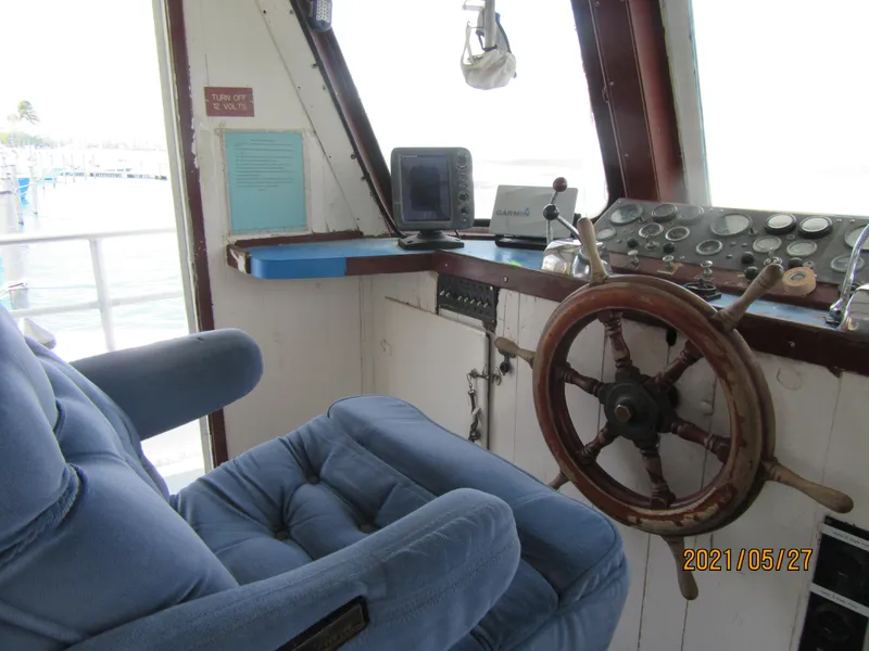 Slide: The Image of Interior of 1986 Drift Fishing Party boat with steering wheel and control panel. - 28