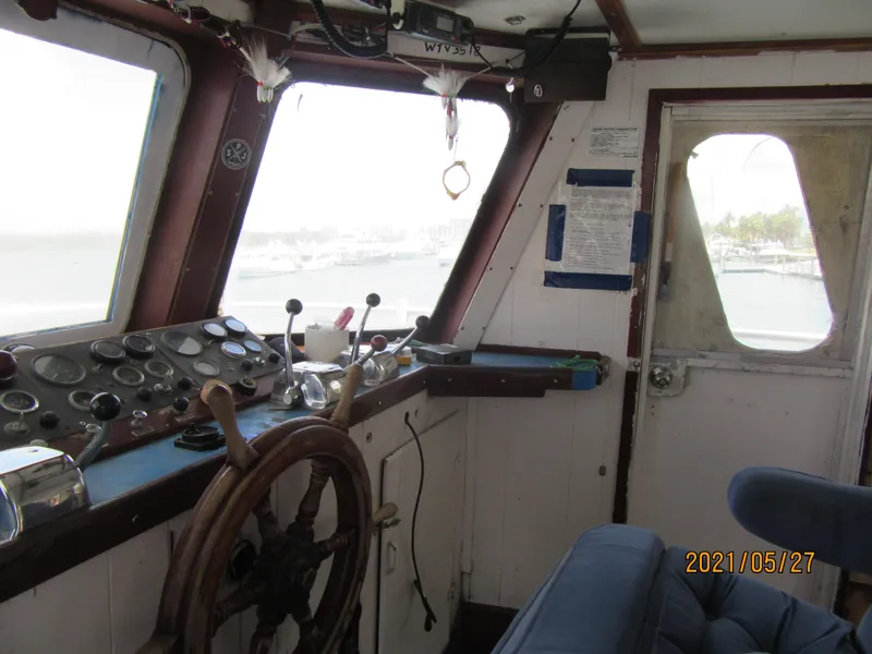 Slide: The Image of Interior of 1986 Drift Fishing Party boat, featuring steering wheel and control panel. - 29