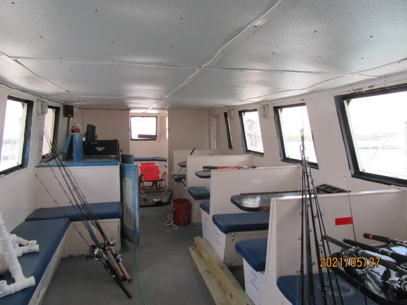 Slide: The Image of Interior of 1986 Drift Fishing Party boat with seating and fishing rods. - 37