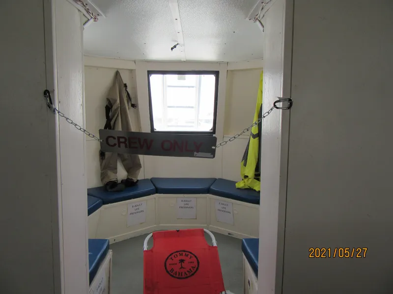 Slide: The Image of Interior of 1986 Drift Fishing Party boat, crew-only area with seating and safety gear. - 40