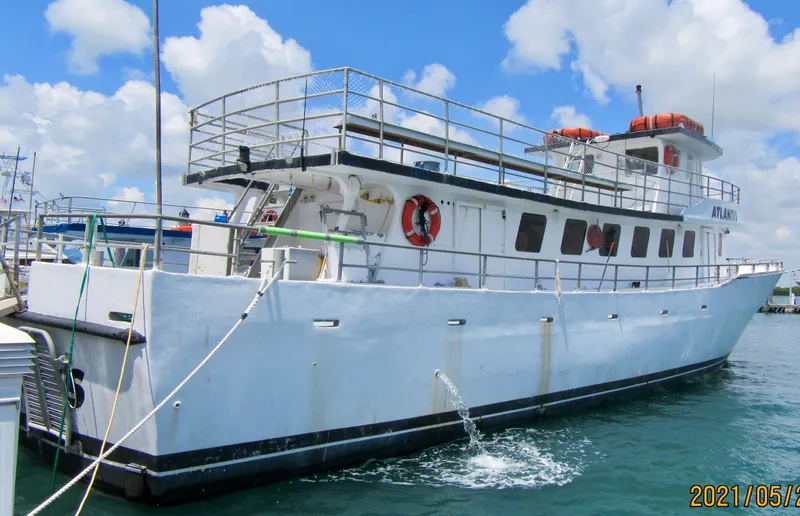 Slide: The Image of 1986 commercial drift fishing boat docked under blue sky. - 49