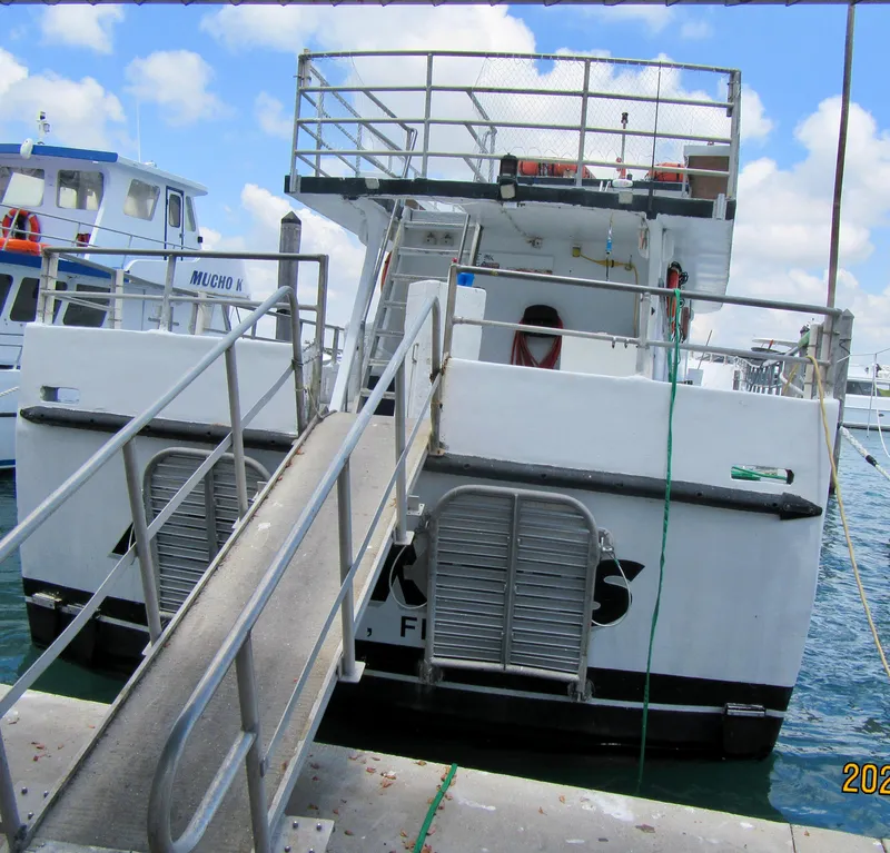 Slide: The Image of Commercial drift fishing boat docked, 1986 model, with boarding ramp and upper deck. - 5
