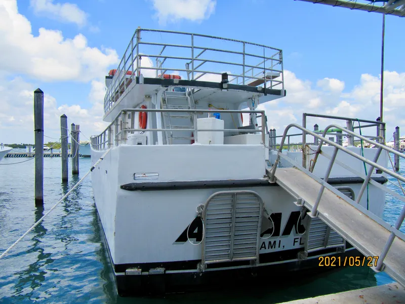 Slide: The Image of Commercial drift fishing boat docked, 1986 model, with upper deck and safety railings. - 6