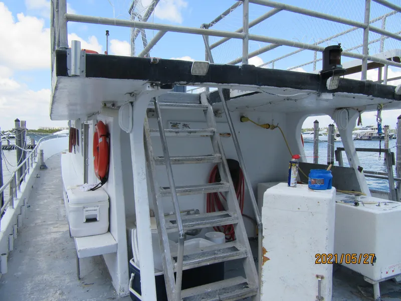 Slide: The Image of 1986 Commercial Drift Fishing Party boat with ladder and safety equipment docked at marina. - 9