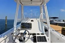 Slide: The Image of 2024 Steiger Craft 255DV Long Beach CC boat console with steering wheel and navigation system. - 2