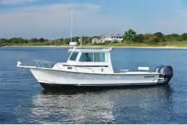 Slide: The Image of 2024 Steiger Craft 28 Fisherman boat on calm water. - 1