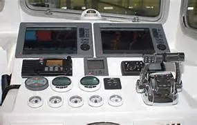 Slide: The Image of 2024 Steiger Craft 31 Fisherman dashboard with dual screens and controls. - 2