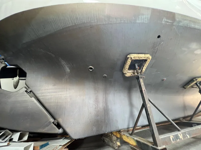 Slide: The Image of 1965 Allied Marine Sea Wind 30 boat hull on stands in a workshop. - 10