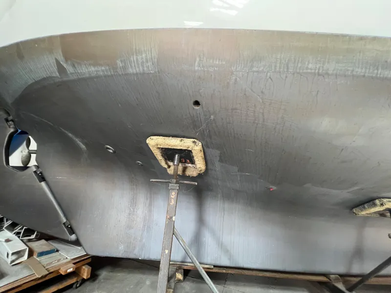 Slide: The Image of Bottom view of a 1965 Allied Marine Sea Wind 30 sailboat in a workshop. - 11