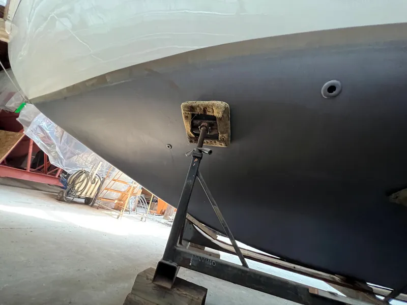 Slide: The Image of 1965 Allied Marine Sea Wind 30 sailboat hull on support stands in a boatyard. - 14