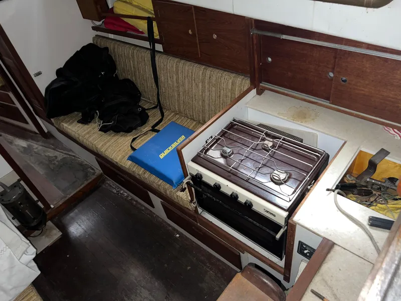 Slide: The Image of Interior of a 1965 Allied Marine Sea Wind 30 sailboat with stove and seating area. - 5