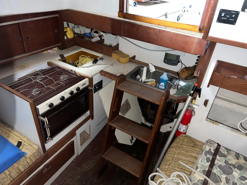 Slide: The Image of Interior of 1965 Allied Marine Sea Wind 30 sailboat with kitchen and wooden cabinetry. - 8