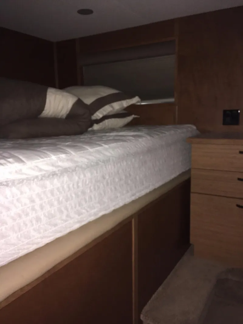 Slide: The Image of 2014 Bravada Imagination Share #4 interior with bed and wooden cabinetry. - 16